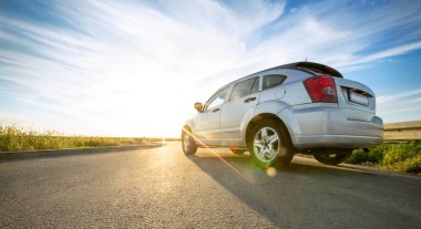 car on road over sunny day clipart