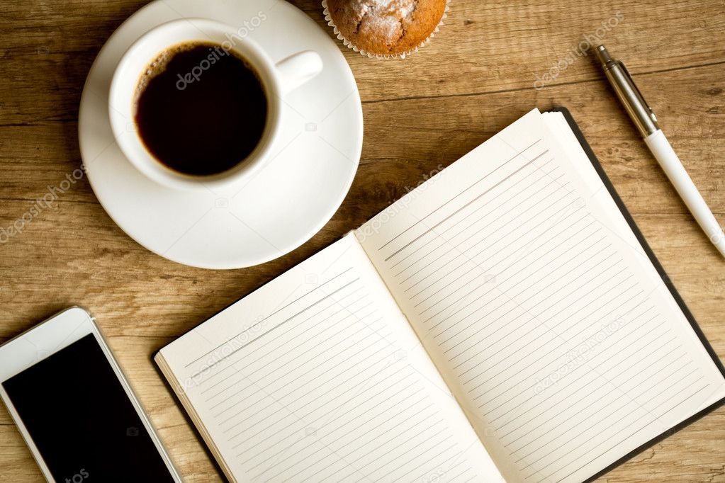 Office table with coffee cup and supplies