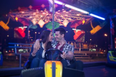 Affectionate couple in amusement park clipart