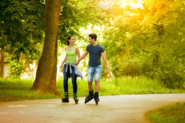 Love couple ride rollerblades — Stock Photo, Image