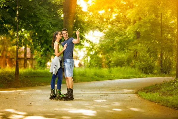 Affectionate couple on rollerblades — Stock Photo, Image