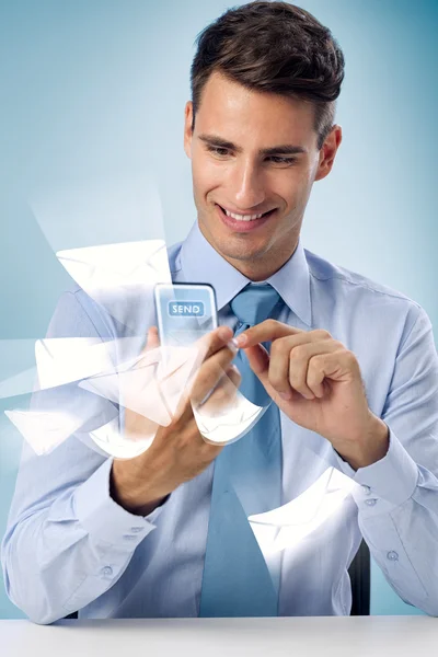 Sending mail - Smiling man using futuristic phone — Stock Photo, Image