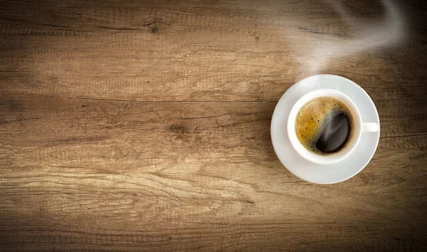 Cup of coffee on wooden background — Stock Photo, Image