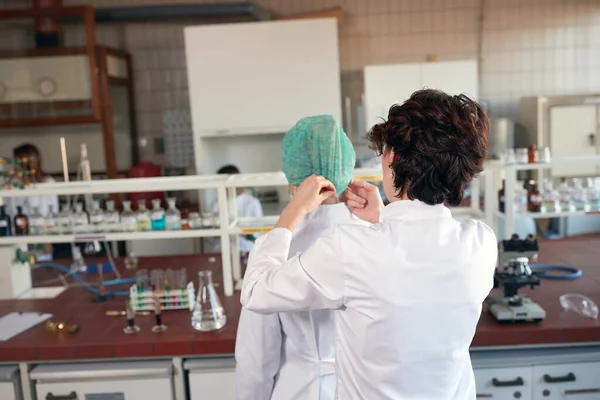 Lab workers in laboratory putting protect cap