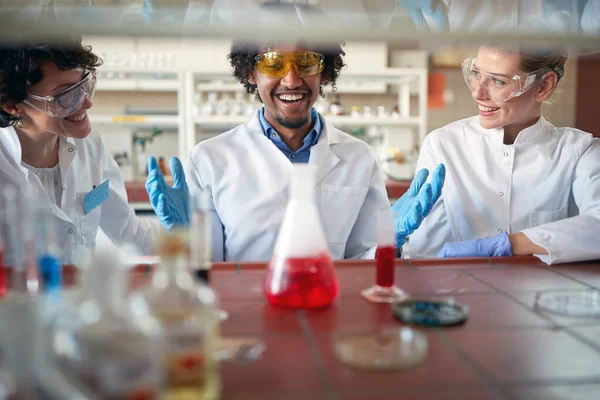 若い化学の学生は 大学の研究室で明るい雰囲気の中で化学物質と一緒に働くのに良い時間を持っています 研究室 — ストック写真