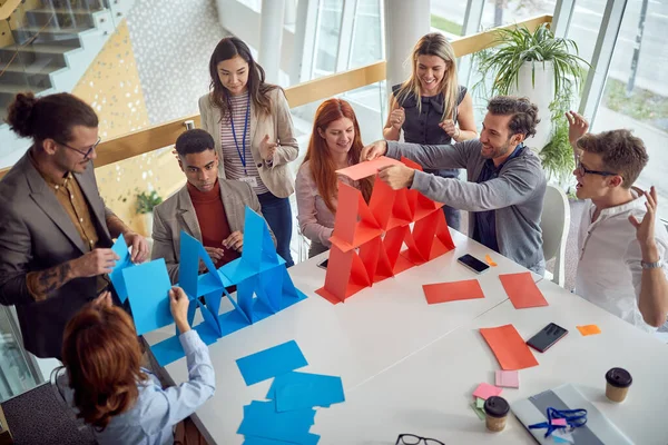 Bird-eye view of a group of young business people playing games in a cheerful atmosphere during a break at work. Business, people, company