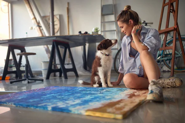 Young Alluring Female Artist Playing Her Dog Studio — Stock Photo, Image