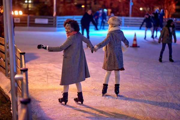 Shot Back Two Female Friends While Skating Ice Skating Rink — Stock Photo, Image