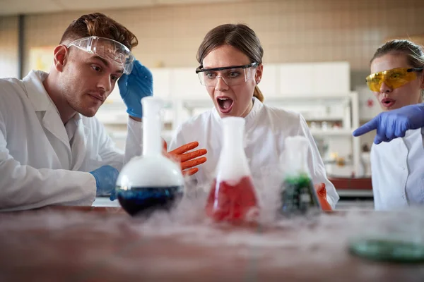 Młodzi Studenci Chemii Zdumieni Reakcją Chemiczną Eksperymentu Laboratorium Uniwersyteckim Atmosferze — Zdjęcie stockowe