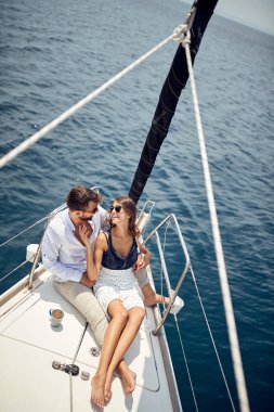 Classy rich couple cruising together on the yacht; Luxurious lifestyle concept