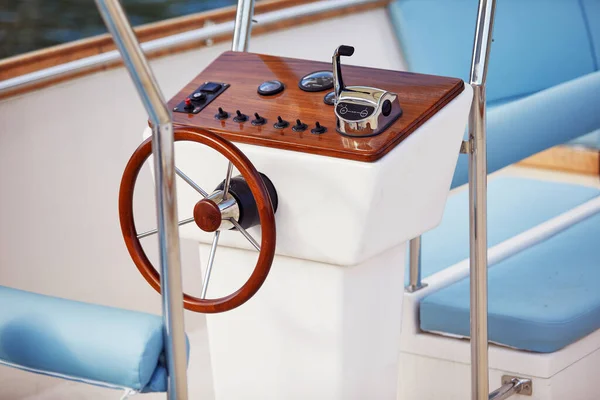 Close-up view of the yacht steering wheel on a beautiful sunny day on the sea. Yacht, sea, summer