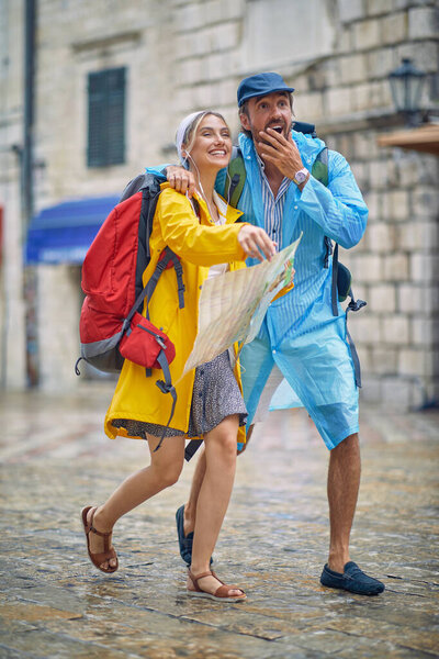 Young Couple Excited While Walking Old City Rainy Day Vacation Stock Picture