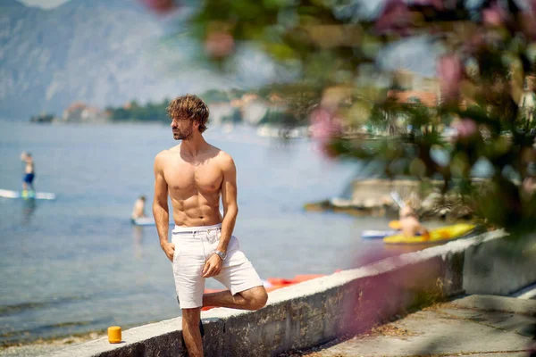 Athletic Handsome Man Posing Deck Water Background Sea European City — Zdjęcie stockowe