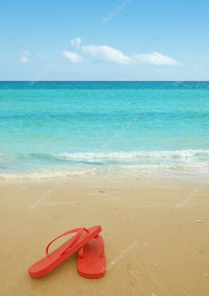 Red flip flops on the beach — Stock Photo © levkro #22671731