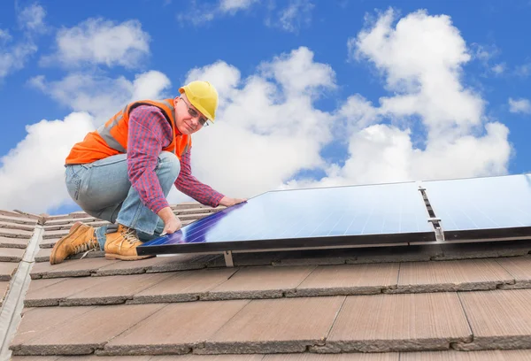 Worker and solar panels Royalty Free Stock Images