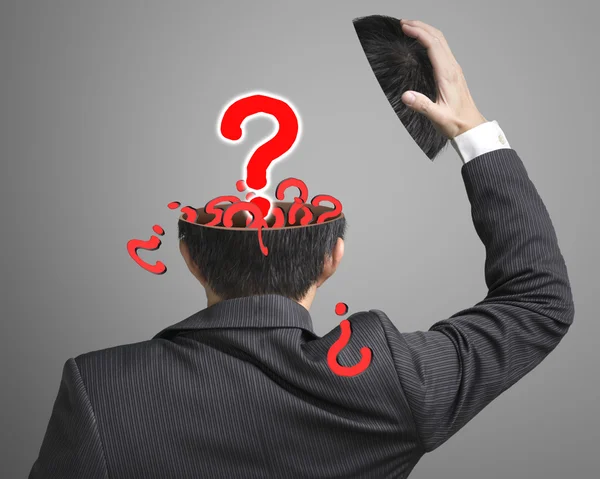 Lleno de preguntas dentro de la cabeza del hombre de negocios con pop-out grande —  Fotos de Stock