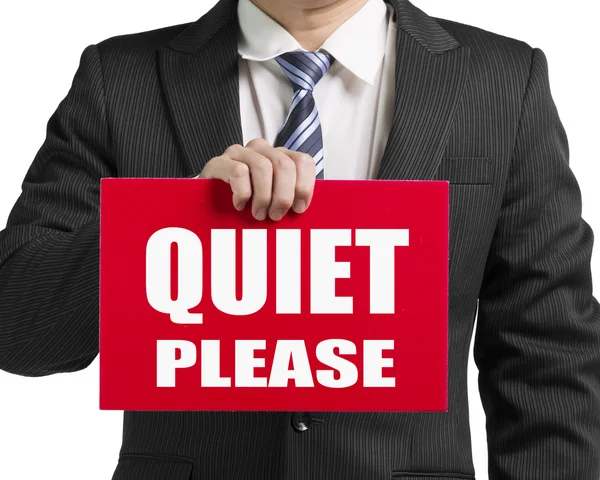 Empresario usa una mano para sostener un tablero rojo con palabras "QUIET P — Foto de Stock