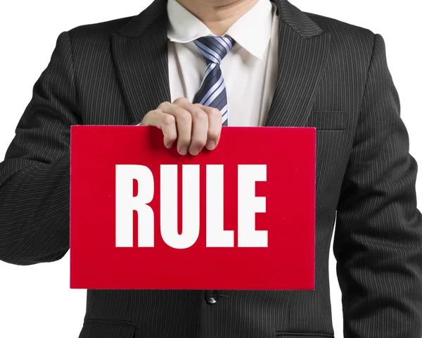 Zakenman gebruik enerzijds te houden een rode bord met het woord "regel" cl — Stockfoto