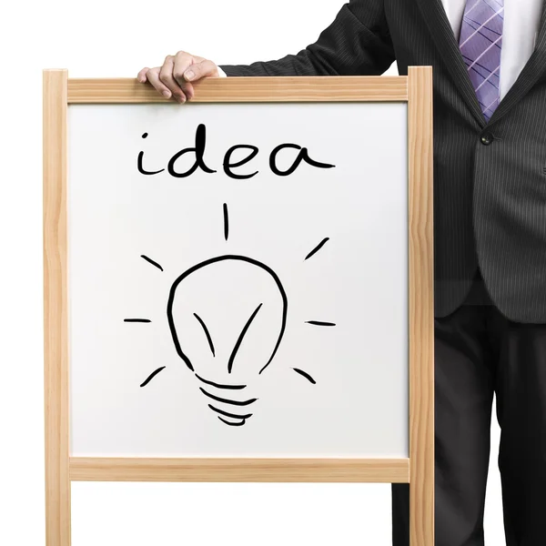 Affärsman hålla vit träplatta med ordet idé och ritning belysning blub på vit bakgrund — Stockfoto