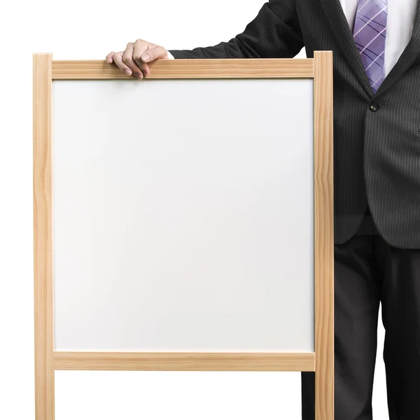 Podnikatel drží dřevěné bílé prázdné deska v bílém pozadí — Stock fotografie