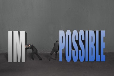 Two businessmen separate word impossible to IM and POSSIBLE to make it possible clipart