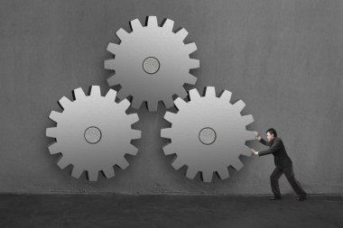 işadamı 3 büyük beton gears beton duvar içinde inişli çıkışlı sırt