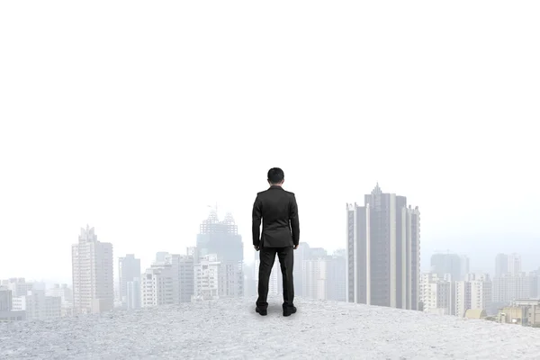 Businessman standing on concrete floor gazing at city — Stock Photo, Image