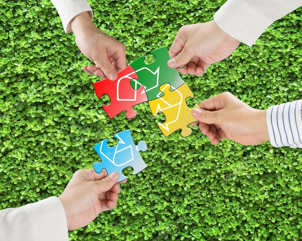 Hands Hold Puzzles With Recycle Symbol In Fresh Meadow Backgroun Stock Photo By C Bruesw