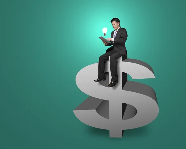 Businessman sitting top of money symbol with tablet, lighting bu — Stock Photo, Image