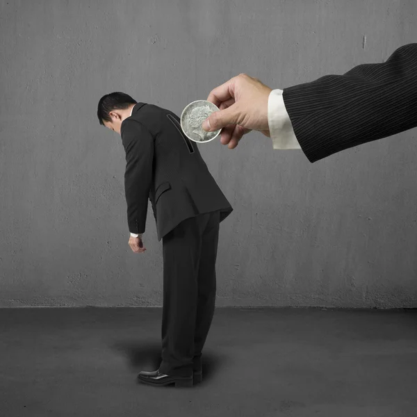 Hand hold money to put into hole on businessman's back — Stock Photo, Image