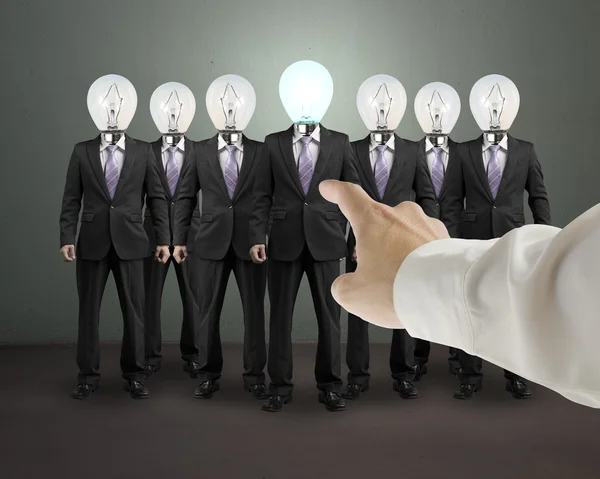 Hand point out one businessman with lighting bulb head — Stock Photo, Image