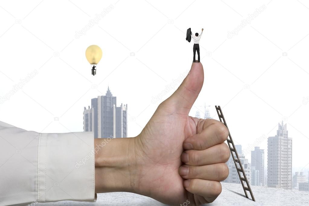 Businessman standing on top of thumb, another in lamp balloon