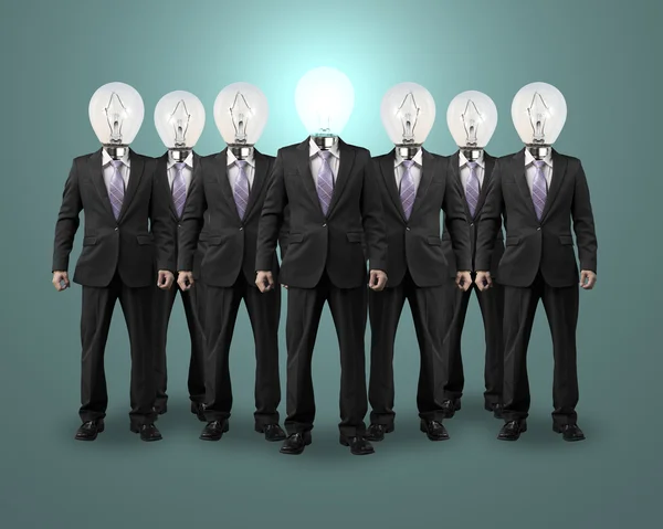 Lighting bulb head businessman standing with group — Stock Photo, Image