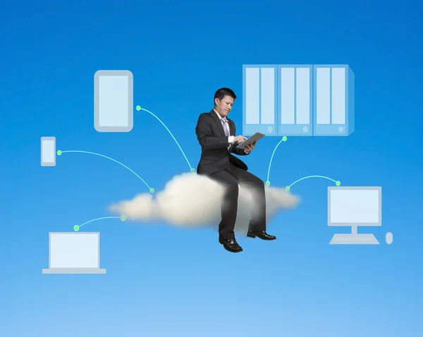 Businessman sitting on cloud using tablet conecting to other dev — Stok fotoğraf