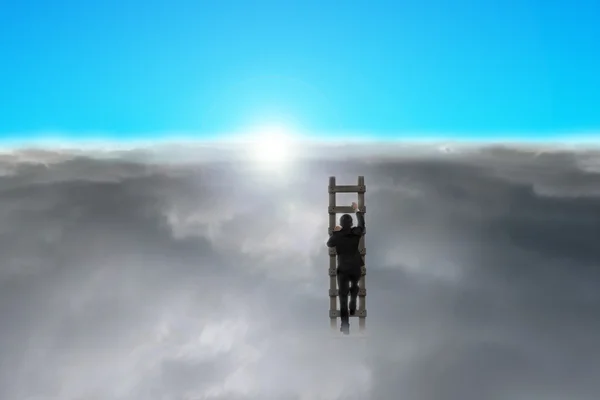 Businessman climbing wooden ladder through cloudy sky — Stock Photo, Image