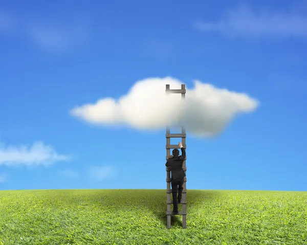 Businessman climbing on wooden ladder to reach cloud — Stock Photo, Image