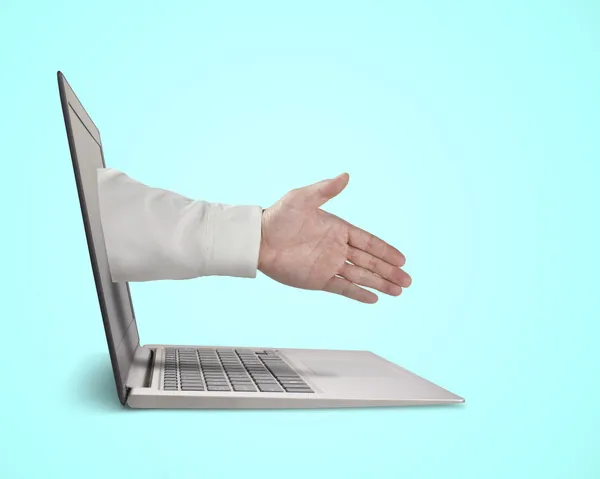Business man hand reaching out from screen to shake with — Stock Photo, Image