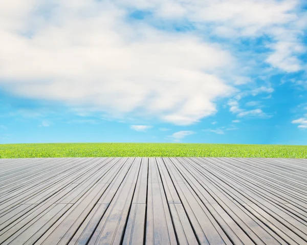 Wood floor with meadow, cloud and blue sky — Stock Photo, Image