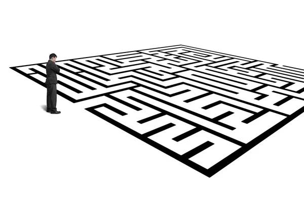 Businessman standing in front of maze isolated in white — Stock Photo, Image