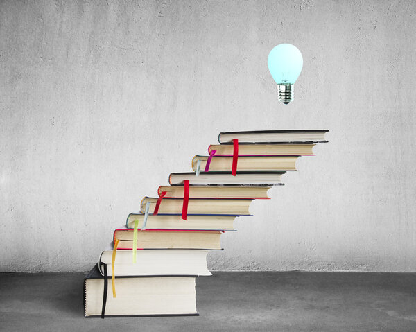 Stack of books with lamp on the top