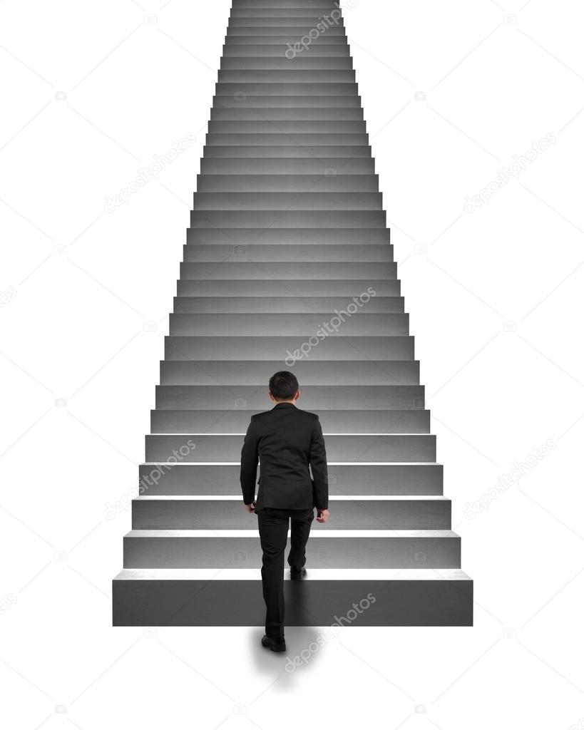 Rear view businessman climbing on stairs isolated in white Stock Photo