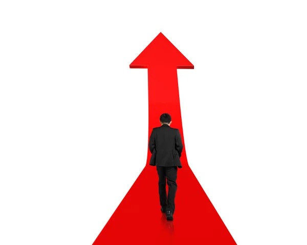 Businessman walking on growing red arrow — Stock Photo, Image