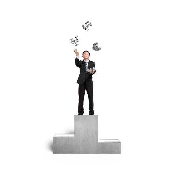 Businessman throwing and catching 3D sliver money symbols on pod — Stock Photo, Image