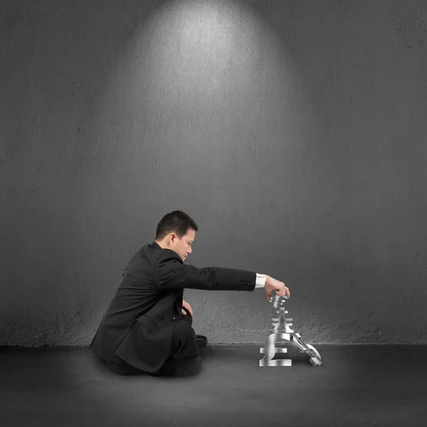 Businessman cross-legged sitting and stacking 3D money symbols — Stock Photo, Image