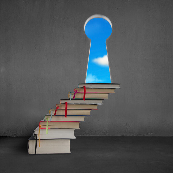 Book stairs to key shape door with blue sky outside