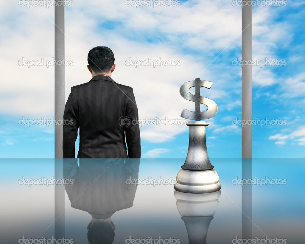 businessman facing blue sky with USD symbol piece on table