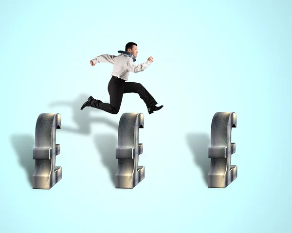 Businessman jumping over pound symbol — Stock Photo, Image