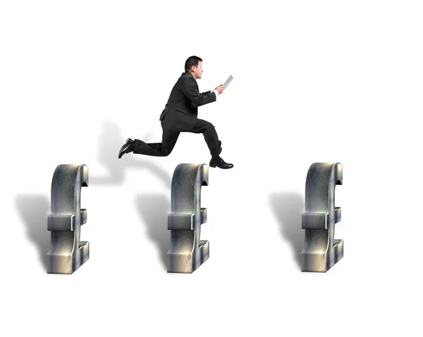 Businessman jumping over 3d pound symbols — Stock Photo, Image