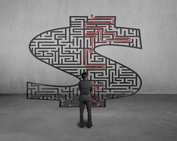 Businessman facing money shape maze with solution — Stock Photo, Image