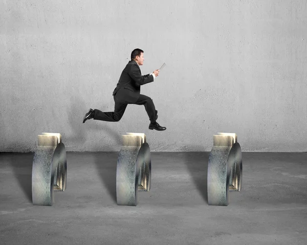 Businessman jumping over euro symbol — Stock Photo, Image